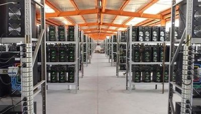 A large-scale mining farm showcasing rows of ASIC miners operating 24/7